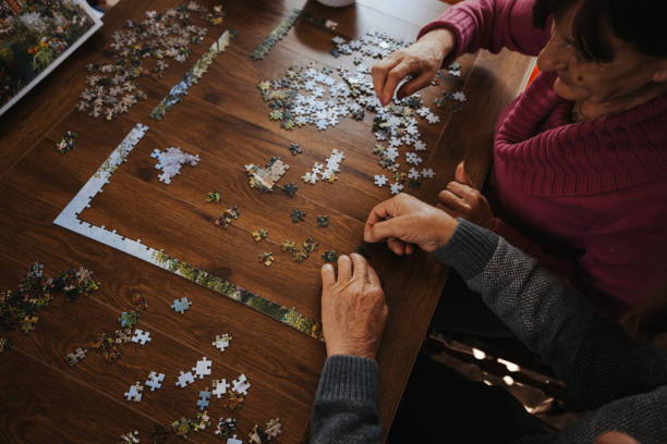 istock Concentrated senior couple doing a jigsaw puzzle at home 1335206529