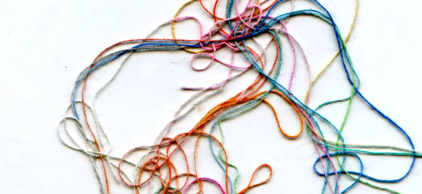 istock Multicolor tangled color needlecraft silk cord. Abstract color background, in white background 1335208024