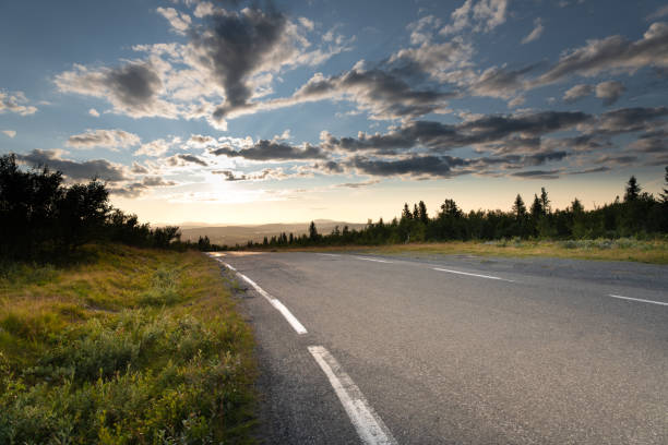 istock Mountain road driving into the sunset 1335208776