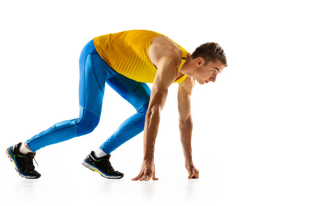 Before runner's start. Caucasian professional male athlete, runner training isolated on white studio background. Muscular man. Concept of action, motion, youth, healthy lifestyle. Copyspace for ad.