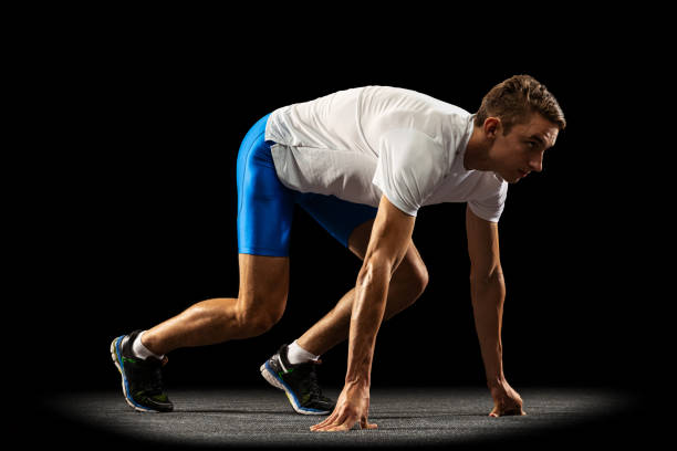 istock Sportive young man, male athlete, runner training isolated on dark studio background with spotlight. Concept of action, motion, youth, healthy lifestyle. 1335210211