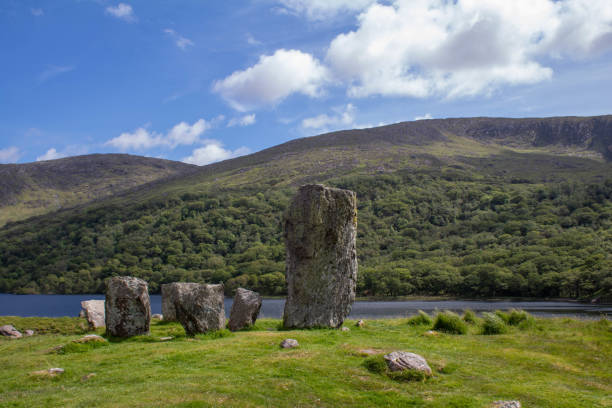 Located on the Beara Peninsula on a small hill between lough Cloonee and Lough Inchiquinn the monument consists of a five stone circle beside a large standing stone.  This circle is set in an incredible valley, with a nice waterfall in the distance.