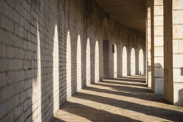 istock Sunlight casting shadow at colonnade in Brompton cemetery in London 1335213654