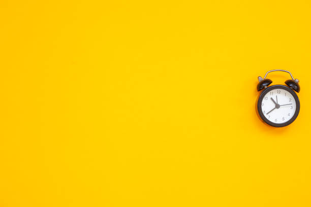 istock black alarm clock on yellow background

￼ 1335216941