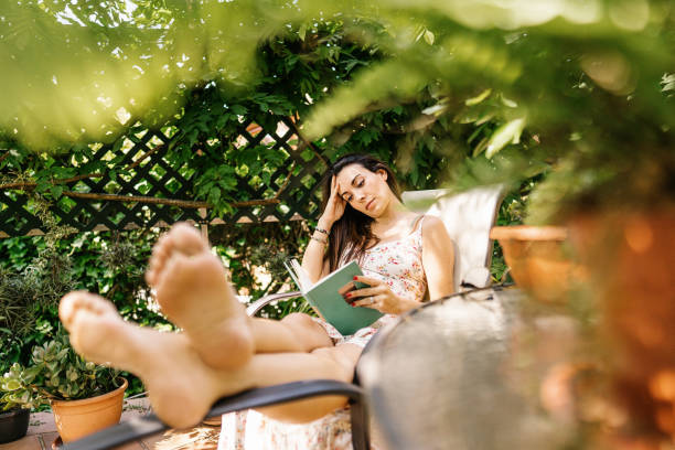 istock Pregnant female on chair reading book 1335217444
