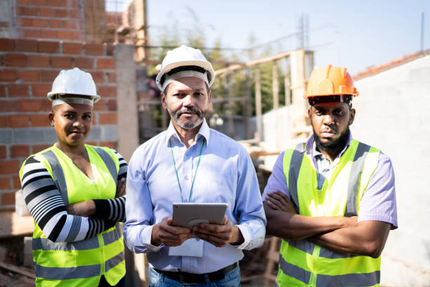 istock Portrait of construction workers at a building site 1335220596