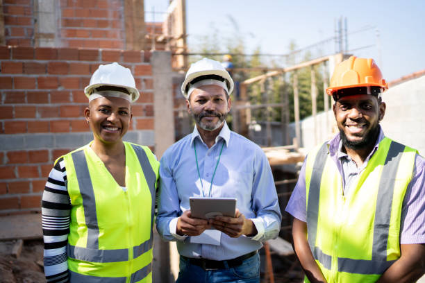 istock Portrait of construction workers at a building site 1335220623