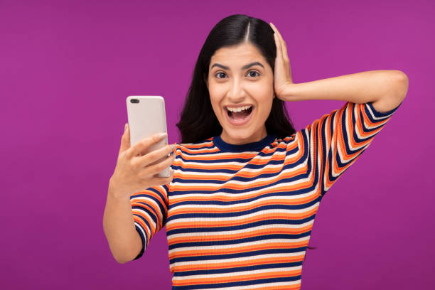 istock Young woman on purple background 1335223145