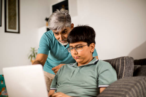 istock Happy father and son using laptop at home 1335223214