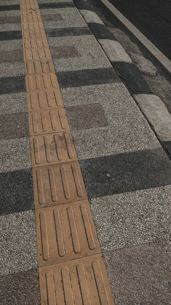 istock Special lane for the blind on the pedestrian path 1335223310