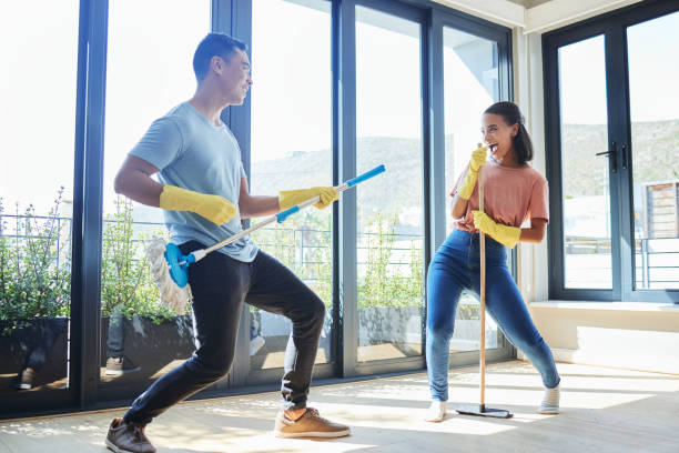Shot of a couple taking a break from mopping their house to dance around Feeling young at heart mop photos stock pictures, royalty-free photos & images