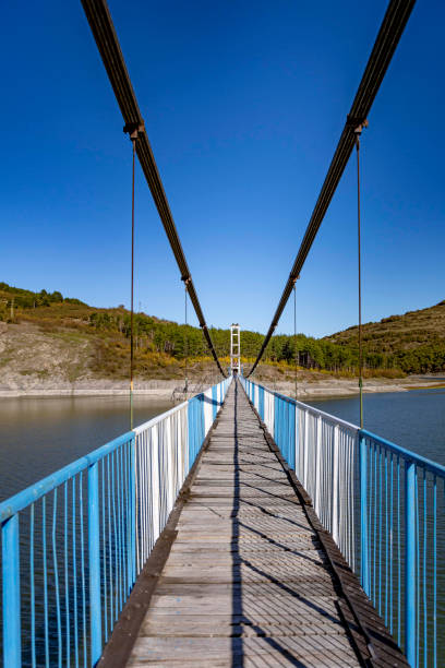 istock Rope bridge above an autumn lake 1335226519