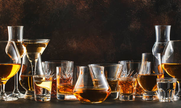 Strong alcoholic drinks, spirits and distillates iset in glasses: cognac, scotch, whiskey and other. Black bar counter background Strong alcohol drinks, hard liquors, spirits and distillates iset in glasses: cognac, scotch, whiskey and other. Black bar counter background tequila drink photos stock pictures, royalty-free photos & images