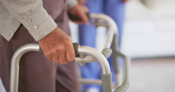 istock Shot of a nurse helping her elderly patient walk using a walking frame 1335229883