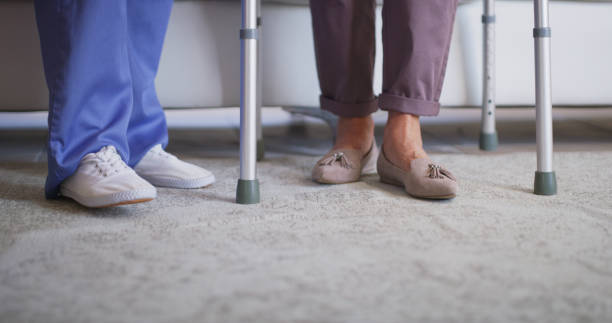 istock Shot of a nurse helping her elderly patient walk using a walking frame 1335229891