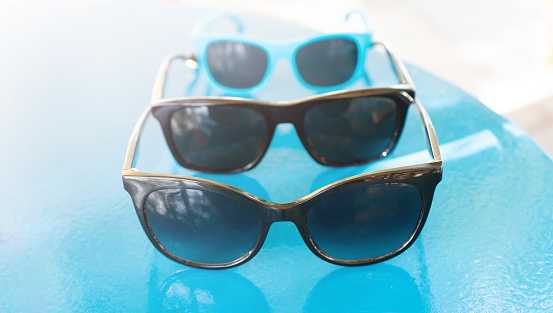 Sunglasses for men, women and children. Family vacation by the sea concept .