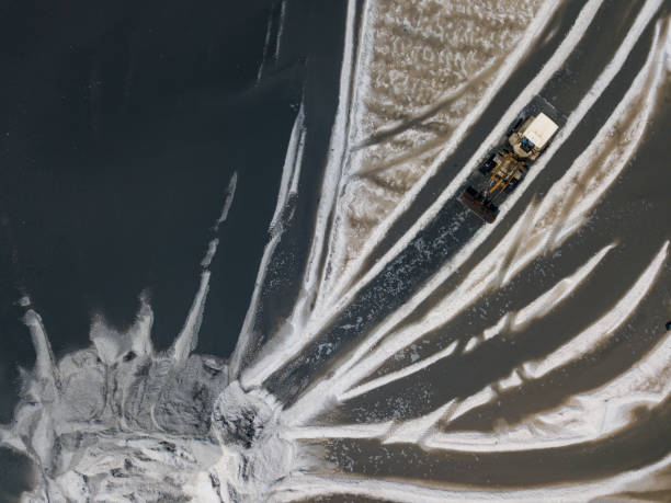 istock Bulldozer is pull of white sand on the swamp 1335231992