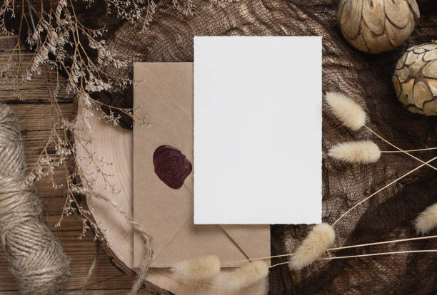 istock Blank paper card and envelope on a wooden table with dried plants 1335232056