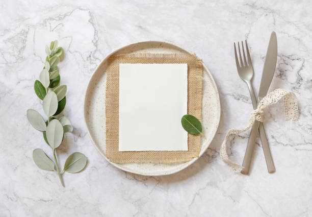 istock Blank paper card on a white plate with eucalyptus branches and ribbons 1335232081
