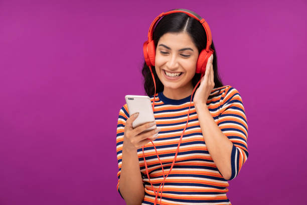 istock Young woman on purple background 1335233914