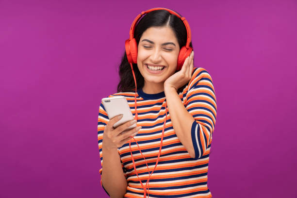 istock Young woman on purple background 1335233933