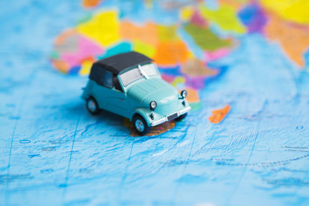 istock retro car on colorful world map, travel 1335234241