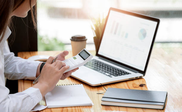 istock Cropped shot of  pretty accountant working with computer and calculator. 1335234246