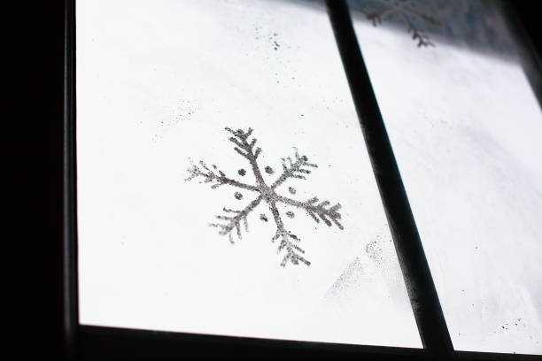 istock beautiful painted snowflake on the window 1335236850