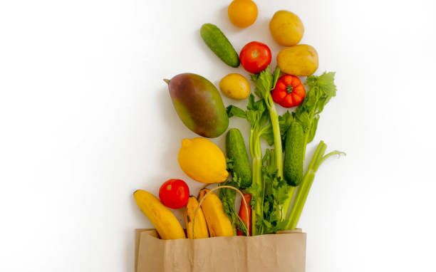 istock paper bag, vegetables and fruits on a white background 1335239069