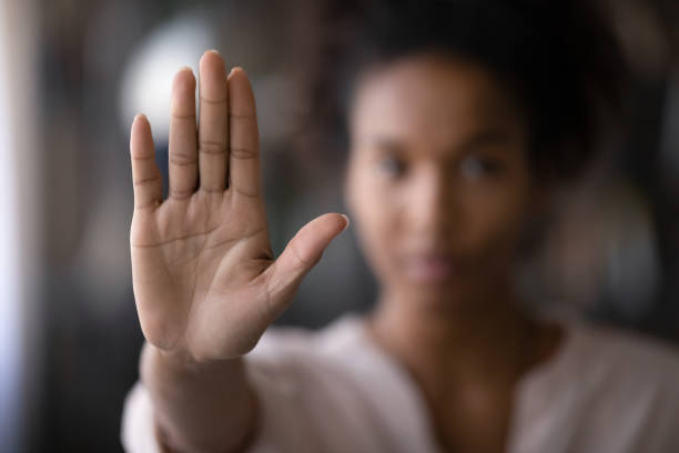 Close up of ethnic woman show palm demonstrate protest Crop close up focus of African American woman show palm hand against racial gender discrimination. Determined mixed race female make sign gesture protest against domestic violence or abortion. stop stock pictures, royalty-free photos & images
