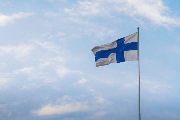 finnish flag - national flag of finland on a blue sky - helsinki, finland - finsk flagga bildbanksfoton och bilder