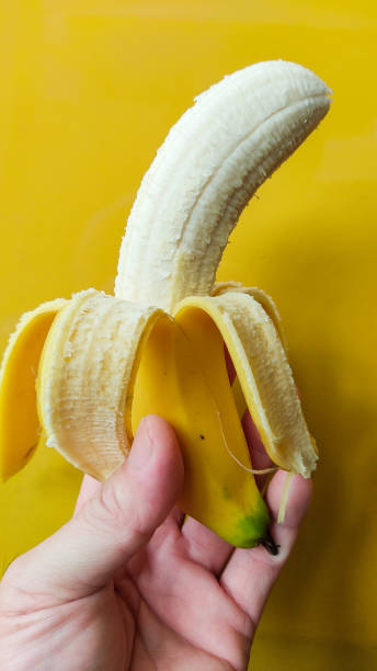 300+ Hand Holding Peeled Banana Stock Photos, Pictures & Royalty-Free ...