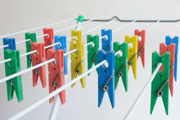 Colored plastic clothespins lined up on the clothesline to dry clothes