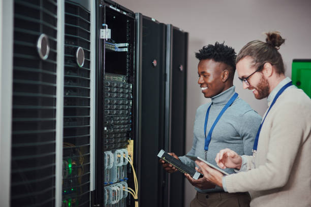 istock Shot of two young technicians using a digital tablet in a server room 1335243519