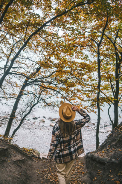 istock Woman walking towards the beach 1335243762