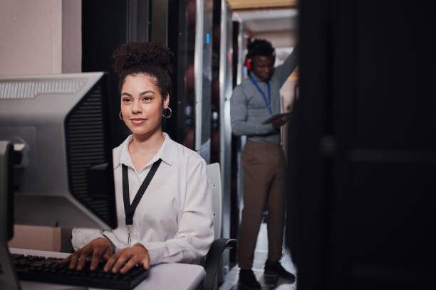 istock Shot of a young woman using a computer while working in a data center 1335246968