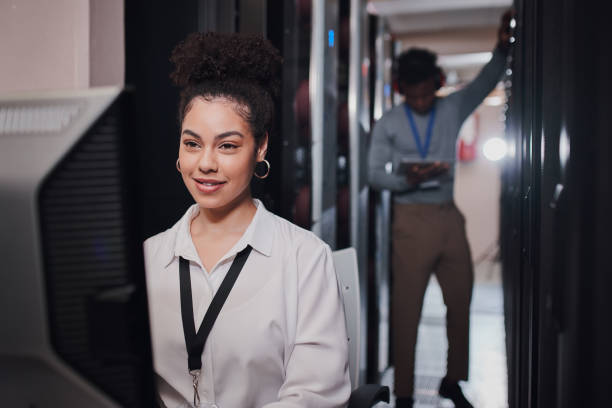 istock Shot of a young woman using a computer while working in a data center 1335246970