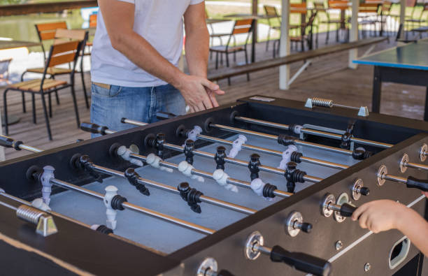 istock Dad and son having fun and playing table football 1335249635