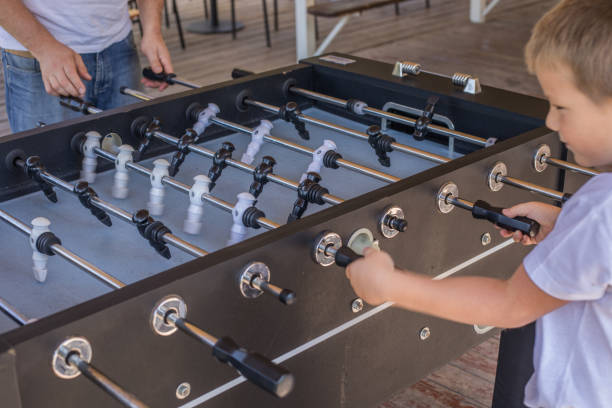 istock Dad and son having fun and playing table football 1335249646