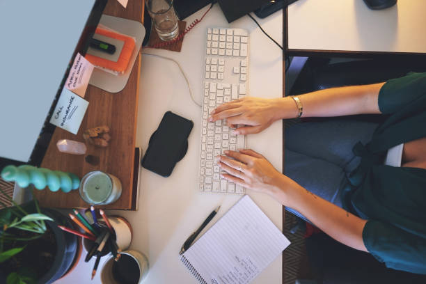 istock High angle shot of an unrecognizable woman sitting alone and using her computer to work from home 1335249697