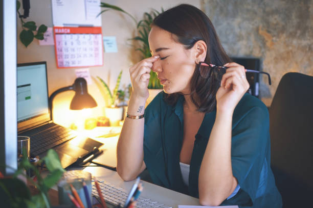 istock Shot of an attractive young woman sitting alone and feeling stressed while using her computer to work from home 1335249700