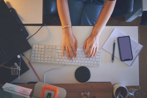 istock High angle shot of an unrecognizable woman sitting alone and using her computer to work from home 1335249726