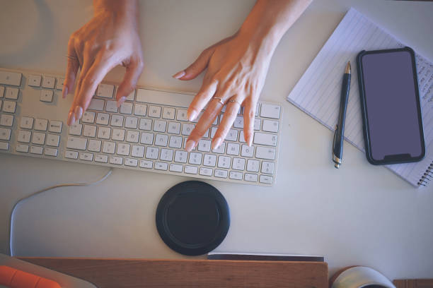 istock High angle shot of an unrecognizable woman sitting alone and using her computer to work from home 1335249729