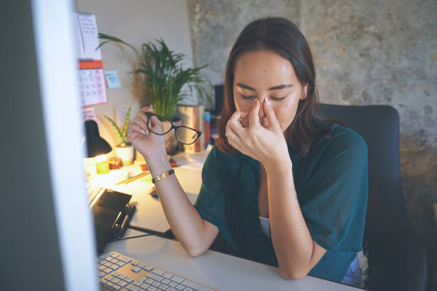 istock Shot of an attractive young woman sitting alone and feeling stressed while using her computer to work from home 1335249737