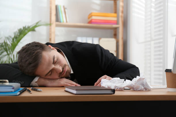 istock Lazy employee sleeping at table in office 1335251132