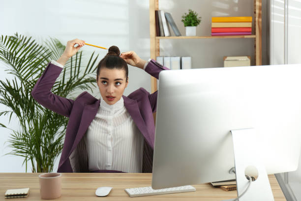 istock Lazy employee playing with pencil at table in office 1335252494