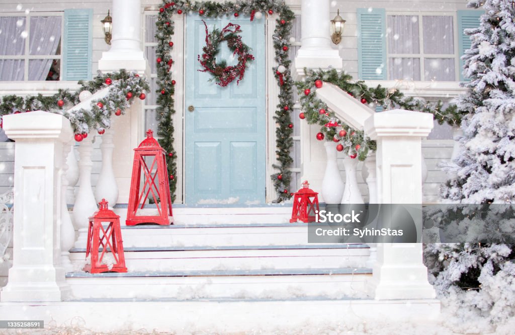 Christmas porch.Snowy courtyard with Christmas porch, veranda, wreath, Christmas tree, garland,christmas balls and lanterns. Merry Christmas and Happy New Year Christmas Stock Photo