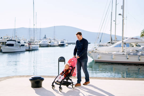 istock Man On Sailboat At Harbor Against Sky 1335258606