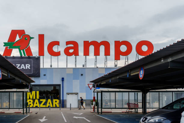 logo and facade of alcampo is a distribution company owned by the french group auchan - store street barcelona shopping mall imagens e fotografias de stock