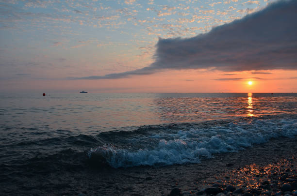 istock Sunset and surf on the beach in Loo, Russia, Krasnodar Territory 1335259105
